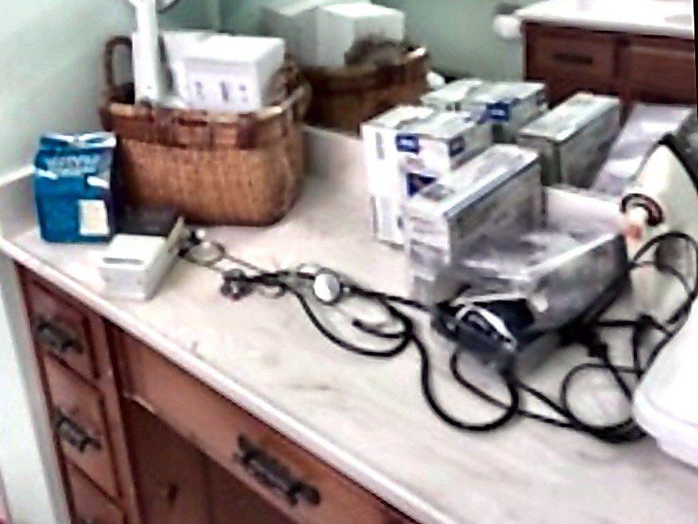 Cluttered bathroom vanity before service